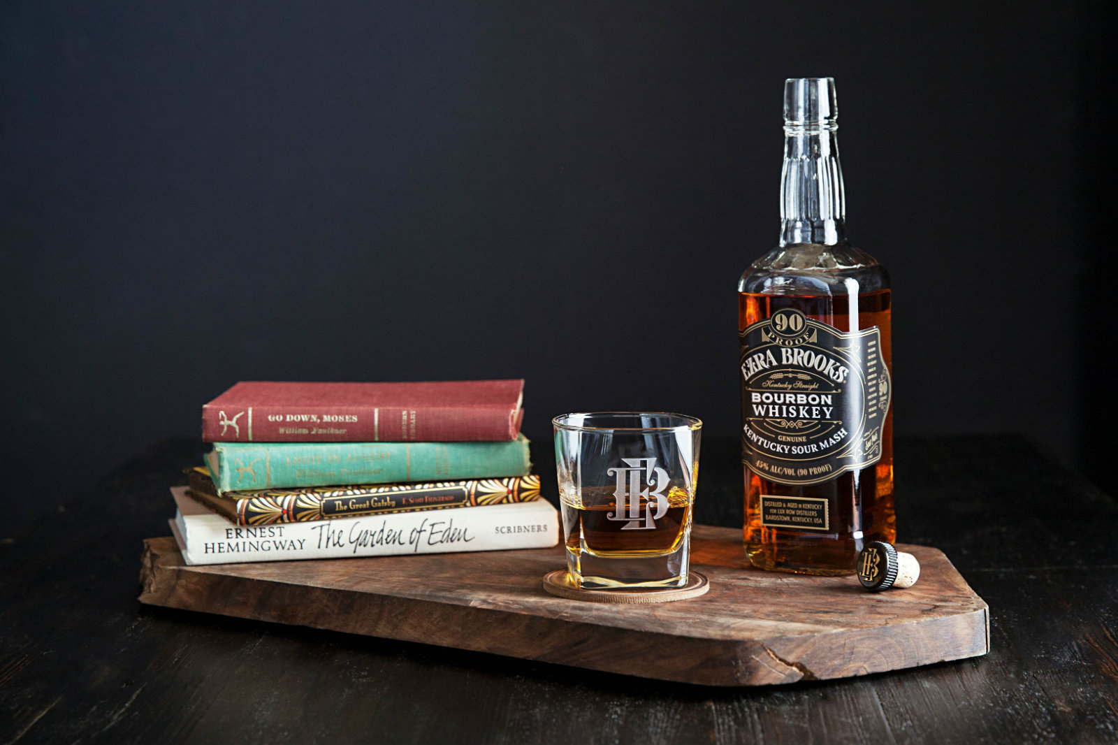 Ezra Brooks bourbon with stack of books